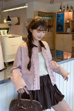 Woman in a stylish outfit standing in a modern interior setting