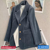 Blue corduroy blazer on a textured surface with 'Toms Cloth' branding.