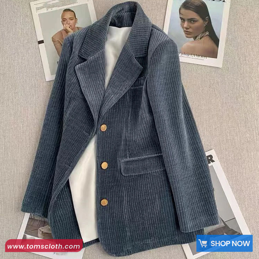 Blue corduroy blazer on a textured surface with 'Toms Cloth' branding.