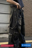 Person wearing dark denim cargo pants with a brick wall background