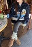 Person wearing a patterned sweater and Ugg boots sitting at a cafe.