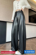 Person wearing a white cropped sweater and black leather pants indoors.