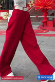 Person wearing red pants with a blurred background