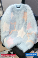 Light blue fluffy sweater with star patterns on a chair