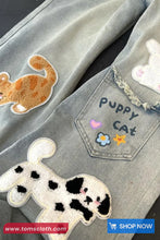 Denim Pants with animal patches and 'Puppy Cat' text, brand 'Toms Cloth' visible.