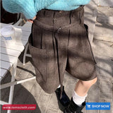 Person wearing brown shorts with a blurred background