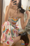 Person wearing a colorful dress with floral patterns and Doc Martens boots indoors.