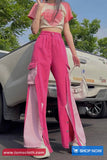 Person wearing a pink outfit with a car and trees in the background