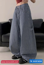 Person wearing blue striped pants with a blurred background