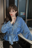 Woman wearing a blue denim jacket indoors