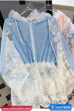 Light blue lace dress on a hanger with a blurred background