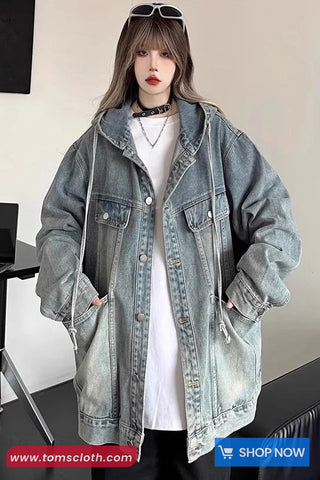 Person wearing a light blue denim jacket indoors with a visible brand logo.