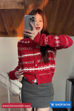 Person wearing a red patterned cardigan taking a mirror selfie.