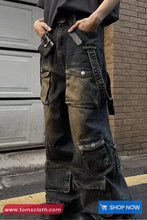 Person wearing dark blue cargo pants with multiple pockets in front of a building.