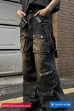 Person wearing dark blue cargo pants with multiple pockets in front of a building.