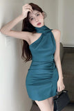 Woman wearing a teal one-shoulder dress indoors.