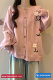 Pink cardigan with embroidered designs on a plain background