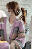 Person wearing a colorful striped cardigan in an indoor setting