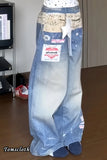 Long blue skirt with a visible brand label on a wooden floor.