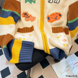Children's sweater with colorful patterns on a checkered floor