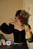 Person holding a bouquet of flowers indoors