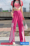 Person wearing a pink outfit with a cityscape background