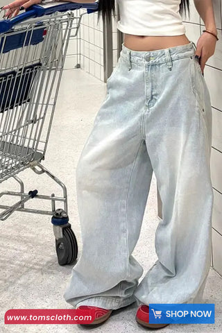 Person wearing light blue jeans with a shopping cart in the background