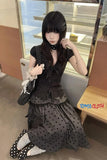 Person wearing a black polka dot outfit sitting on a train with 'TOMS CLOTH' branding.