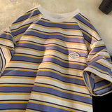Striped long-sleeve shirt with a brand logo on a light background
