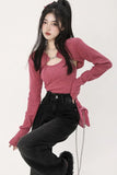 Woman wearing a pink long-sleeve top and black pants on a white background