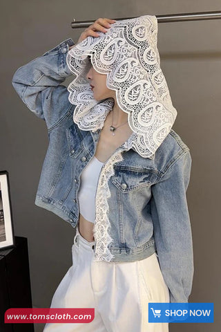 Denim jacket with lace detailing worn by a person, with a gray background and brand logo visible.