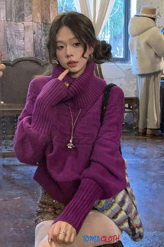 Woman wearing a purple sweater in an indoor setting