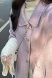 Person wearing a light pink coat with a blurred background