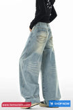 Wide-leg jeans worn by a person on a white background with 'tomscloth.com' branding.