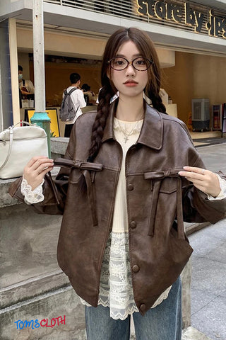 Woman wearing a brown jacket with a store in the background