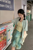 Woman standing next to a poster with a store advertisement in an indoor setting.