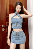 Woman wearing a denim outfit standing in front of a wooden door.