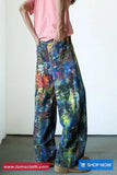 Person wearing colorful pants with a plain background
