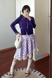 Person wearing a purple cardigan and polka dot skirt taking a mirror selfie.