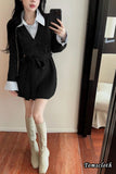 Person wearing a black dress with a white shirt and white knee-high boots, taking a mirror selfie.