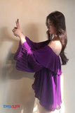 Woman wearing a purple dress against a plain background