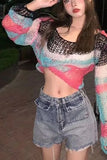 Person wearing a colorful sweater and denim shorts outdoors