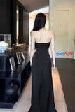 Woman in a black strapless gown standing in a modern interior setting with 'TOMS CLOTH' branding.