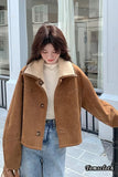 Person wearing a brown jacket with a blurred background