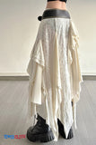 Long white lace skirt with black platform boots on a plain background