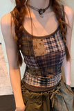 Person wearing a plaid tank top and green pants with a neutral background