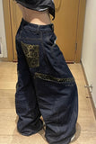 Dark blue jeans with leopard print patches on a wooden floor.
