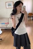 Woman taking a mirror selfie in a room with a couch and framed picture.