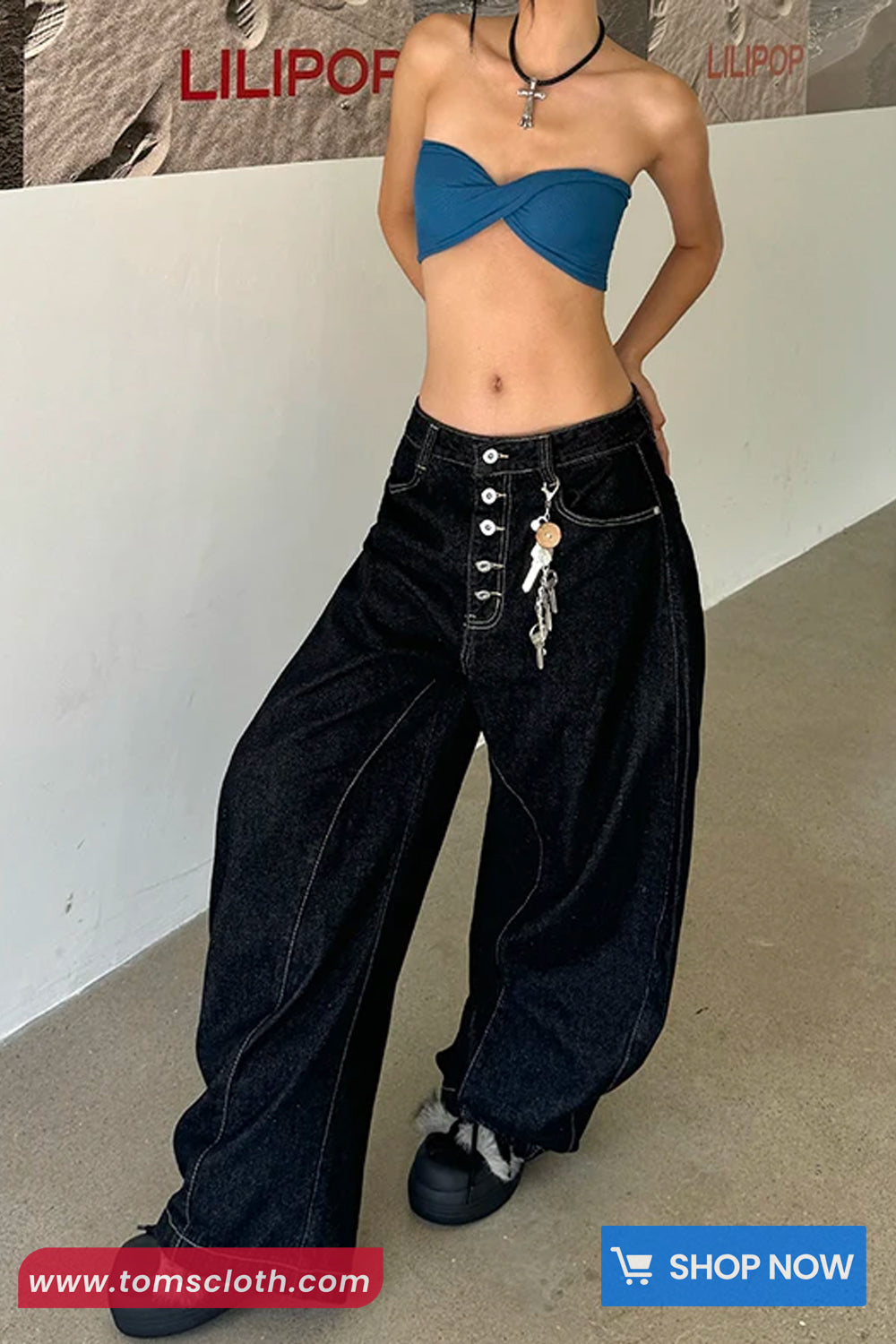 Person wearing a blue top and black wide-leg pants with a white wall and 'LILIPOT' branding in the background.