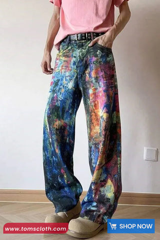 Person wearing colorful pants with a plain background